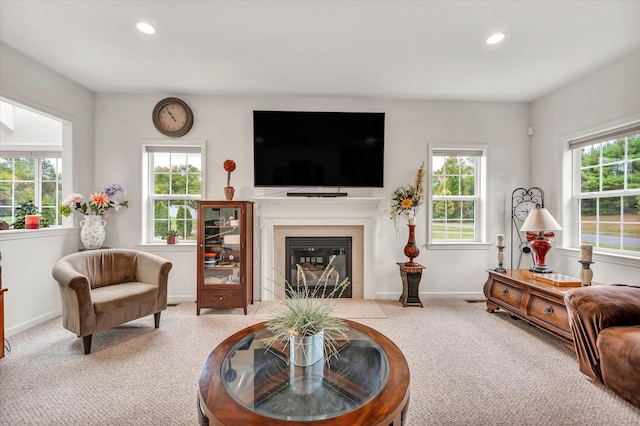 living room with light carpet and a tile fireplace