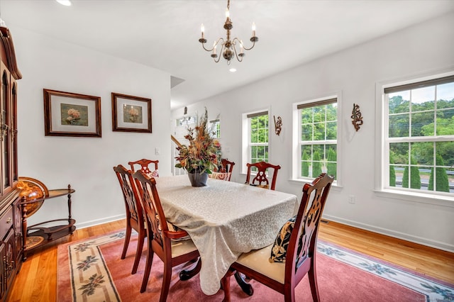 dining room featuring an inviting chandelier and light wood-type flooring