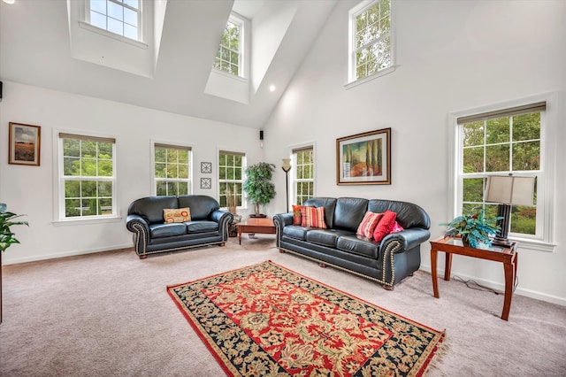 living room with carpet floors, a healthy amount of sunlight, and high vaulted ceiling