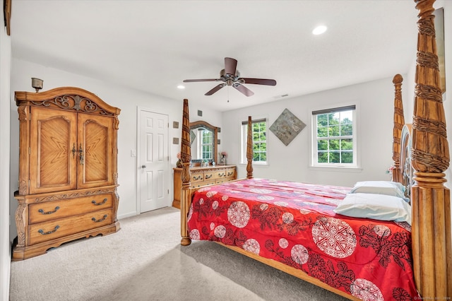 bedroom with ceiling fan and light colored carpet