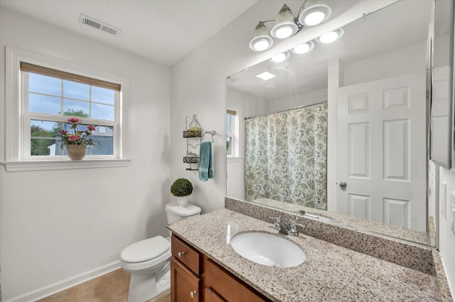 bathroom featuring a shower with curtain, vanity, tile patterned flooring, and toilet