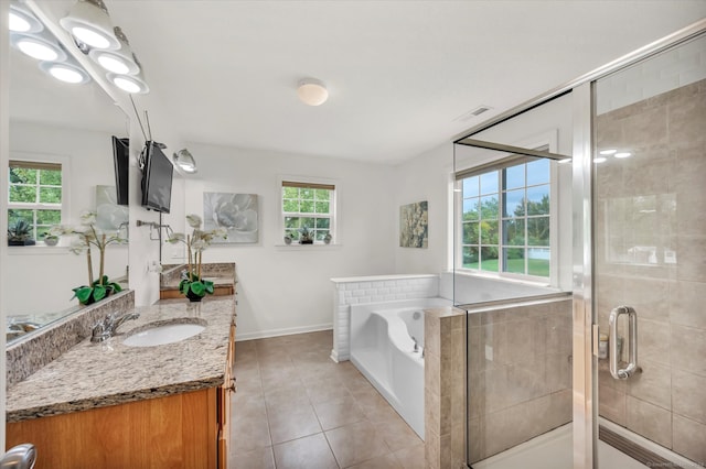 bathroom featuring vanity, plus walk in shower, tile patterned flooring, and a healthy amount of sunlight