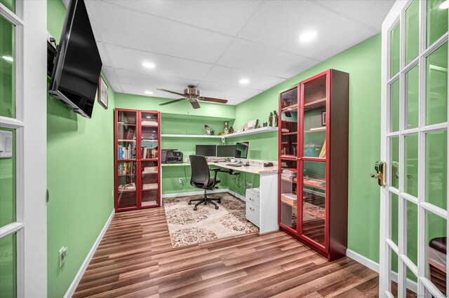 home office featuring a paneled ceiling, hardwood / wood-style floors, and ceiling fan