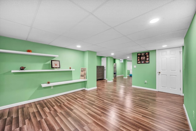 basement featuring a drop ceiling and hardwood / wood-style flooring