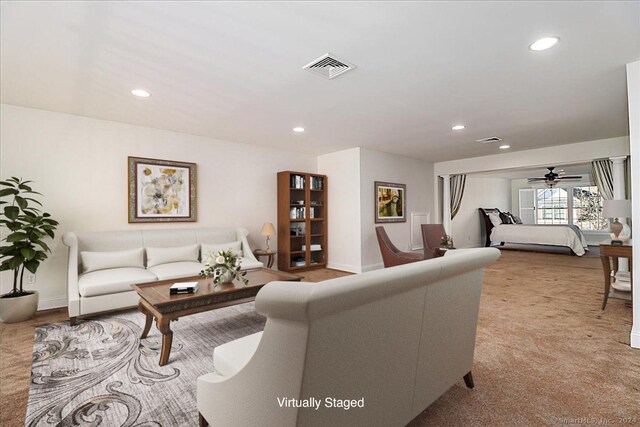 living room featuring ceiling fan and light carpet