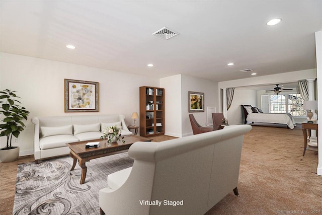 living room with light colored carpet and ceiling fan