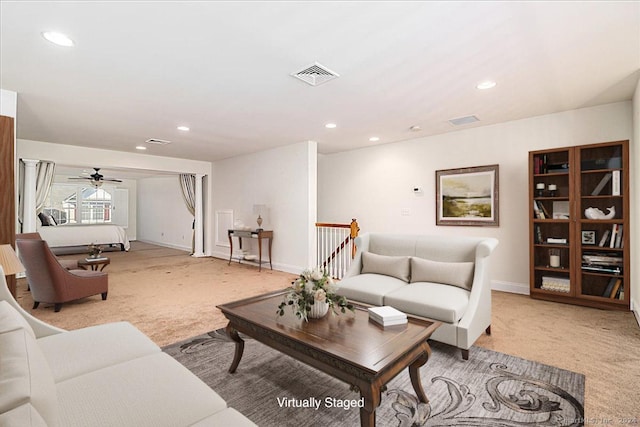 carpeted living room featuring ceiling fan