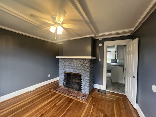 unfurnished living room featuring ceiling fan, crown molding, hardwood / wood-style floors, and a stone fireplace