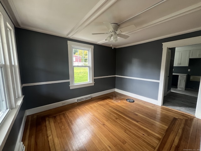 spare room featuring crown molding, ceiling fan, and light hardwood / wood-style flooring