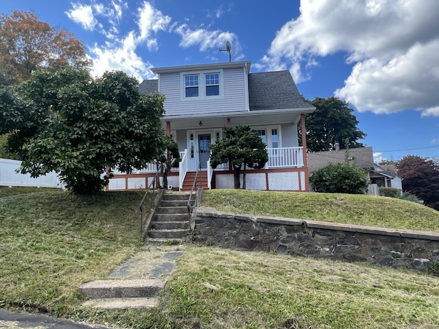 view of front facade with a front lawn and a porch