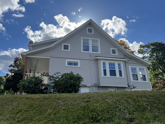 view of side of property with a lawn