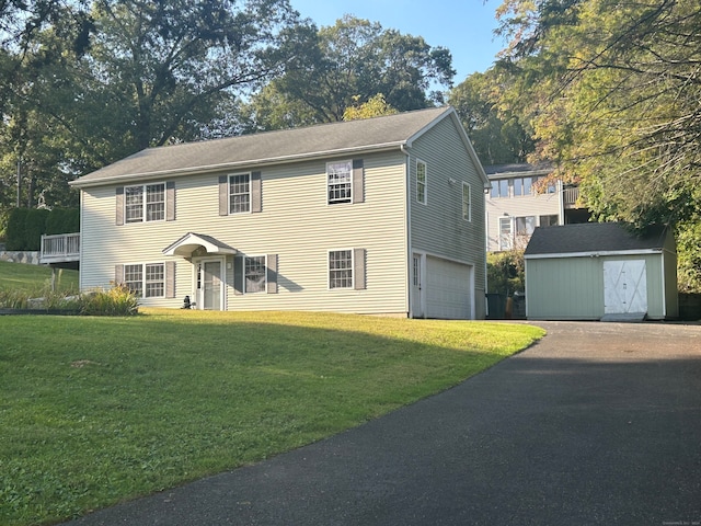 colonial home with a garage and a front lawn