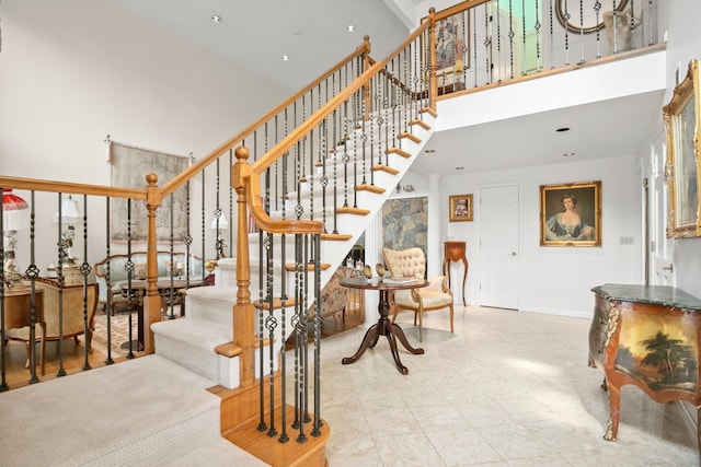 stairs featuring a towering ceiling