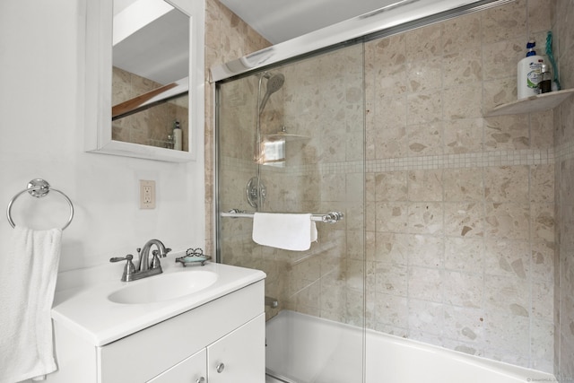 bathroom featuring vanity and bath / shower combo with glass door