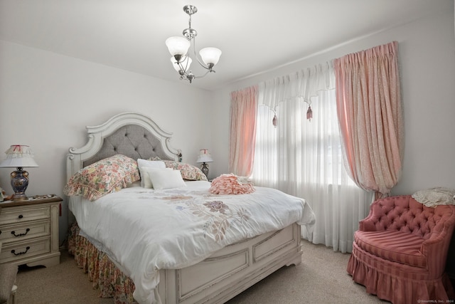 bedroom featuring light colored carpet and a notable chandelier