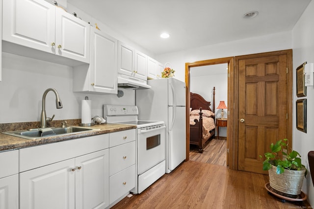 kitchen with light hardwood / wood-style flooring, white appliances, white cabinetry, and sink