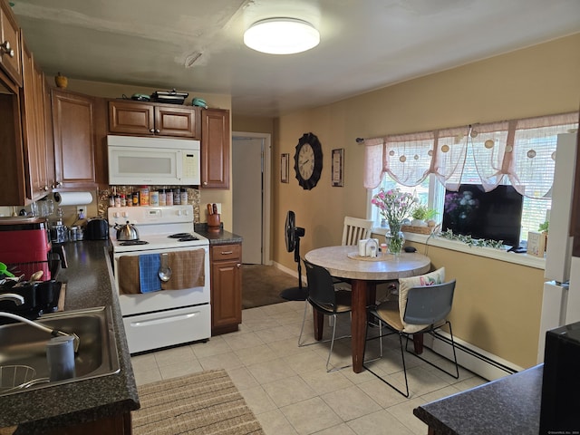 kitchen with sink, a baseboard radiator, decorative backsplash, white appliances, and light tile patterned floors