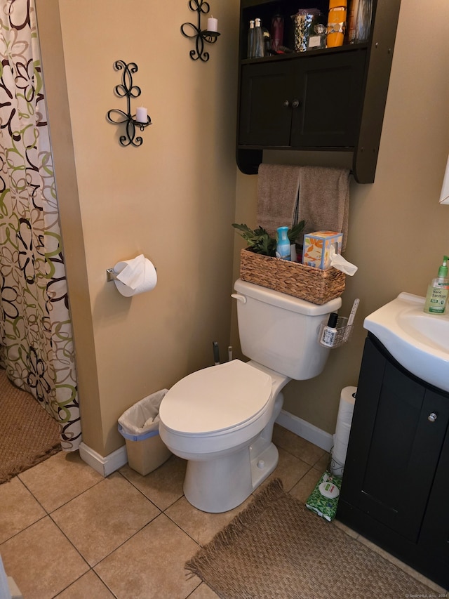 bathroom with tile patterned floors, a shower with curtain, vanity, and toilet