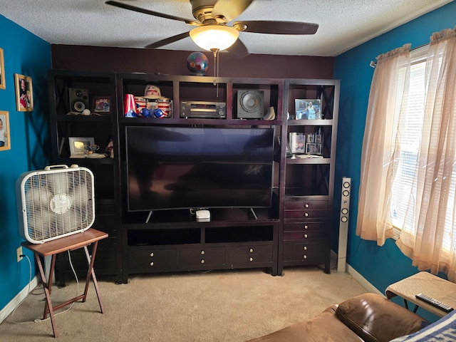 living room featuring ceiling fan, light colored carpet, and a textured ceiling