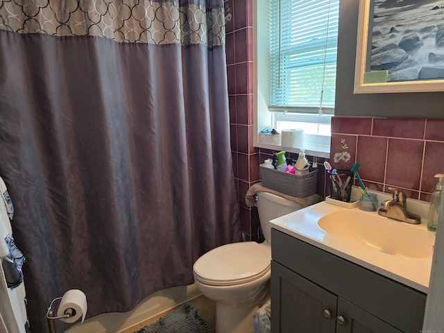 bathroom with tile walls, backsplash, vanity, a shower with shower curtain, and toilet