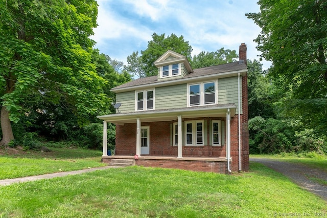 view of front facade featuring a front lawn and covered porch