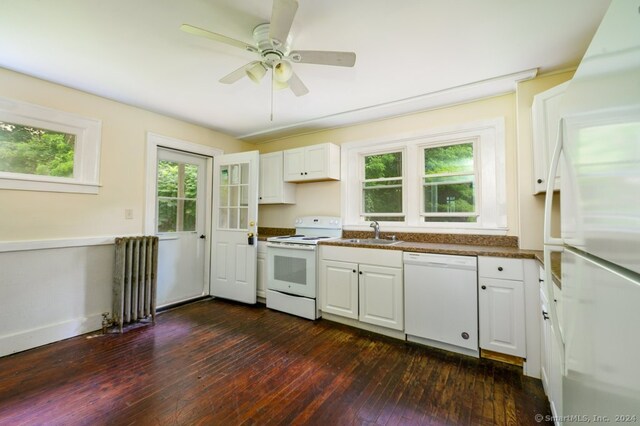 kitchen with white cabinetry, dark wood-type flooring, white appliances, radiator heating unit, and ceiling fan