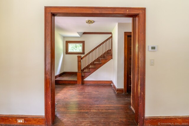 hall with dark hardwood / wood-style floors