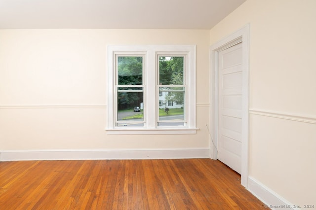 spare room with hardwood / wood-style flooring