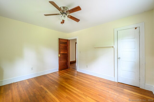 spare room featuring light hardwood / wood-style floors and ceiling fan