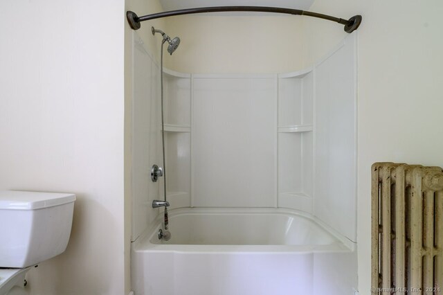 bathroom featuring radiator, shower / bathing tub combination, and toilet