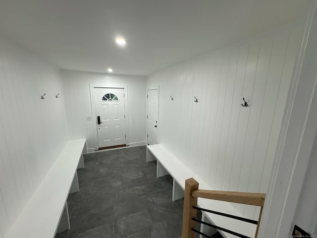 mudroom featuring wood walls