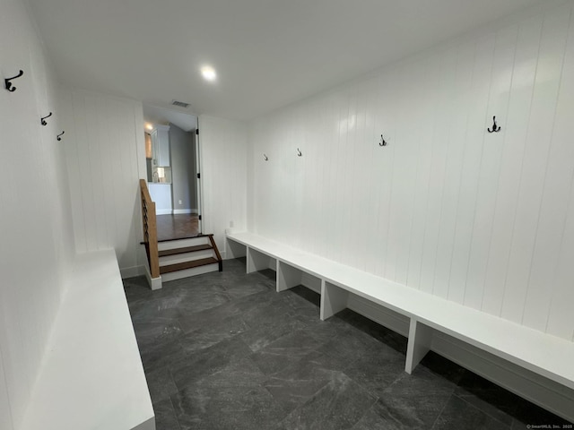 mudroom with wood walls