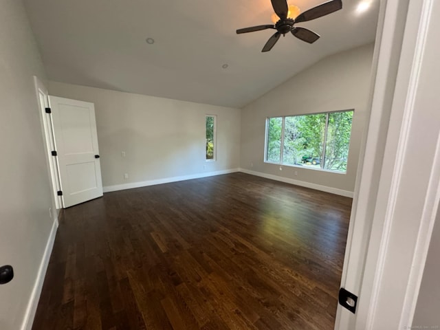 empty room featuring ceiling fan, dark hardwood / wood-style floors, and vaulted ceiling