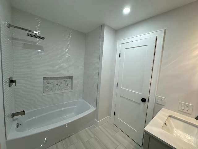 bathroom featuring vanity and tiled shower / bath combo