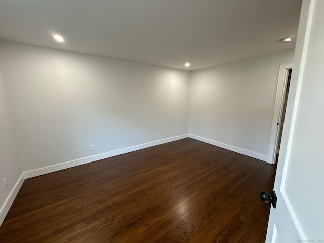 spare room featuring dark hardwood / wood-style flooring