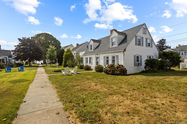 new england style home featuring a front lawn