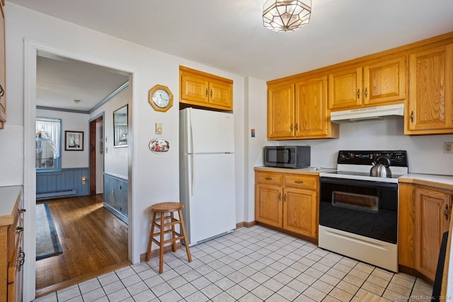 kitchen with light hardwood / wood-style floors, wooden walls, white appliances, baseboard heating, and crown molding