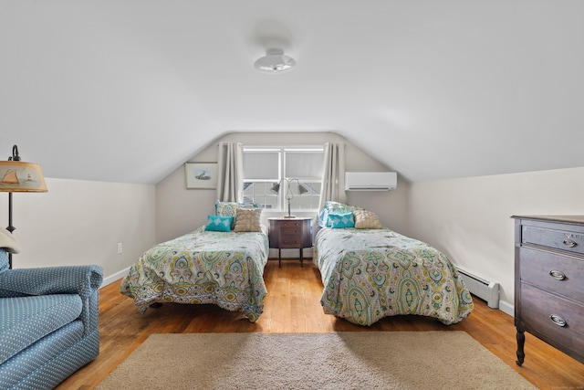 bedroom with hardwood / wood-style flooring, baseboard heating, vaulted ceiling, and a wall unit AC