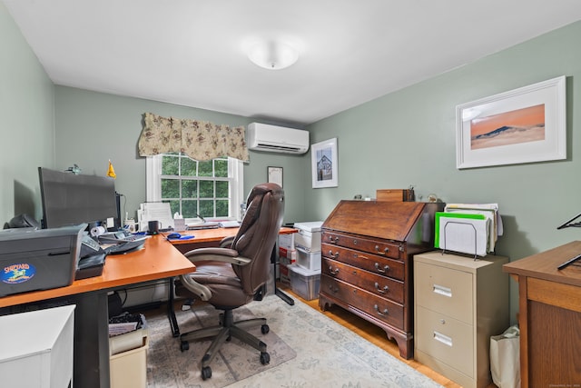 home office with light wood-type flooring and an AC wall unit