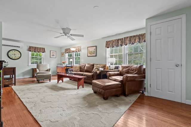 living room with wood-type flooring, ceiling fan, and a wealth of natural light