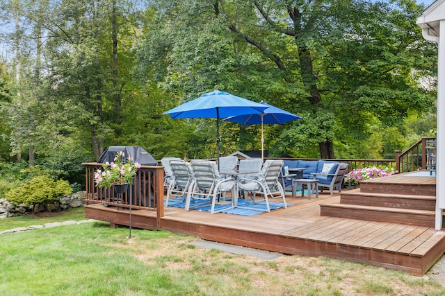 wooden terrace with outdoor lounge area and a yard