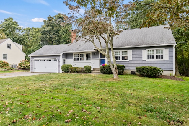 view of front of home with a garage and a front lawn