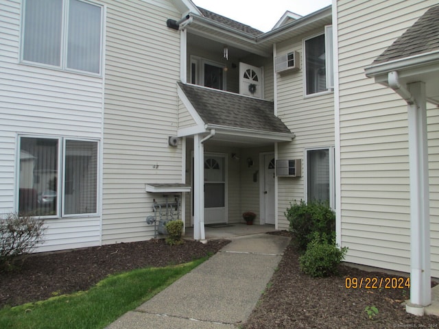 doorway to property with a wall mounted AC