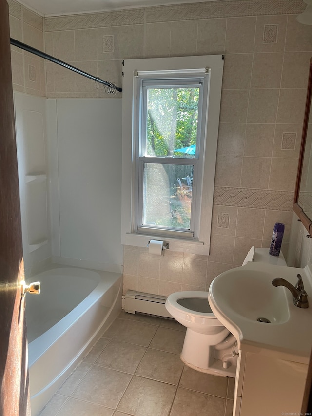 full bathroom with vanity, tile walls, toilet, a baseboard radiator, and shower / tub combination