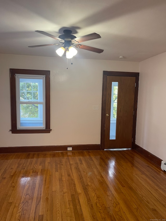 unfurnished room with hardwood / wood-style floors and ceiling fan