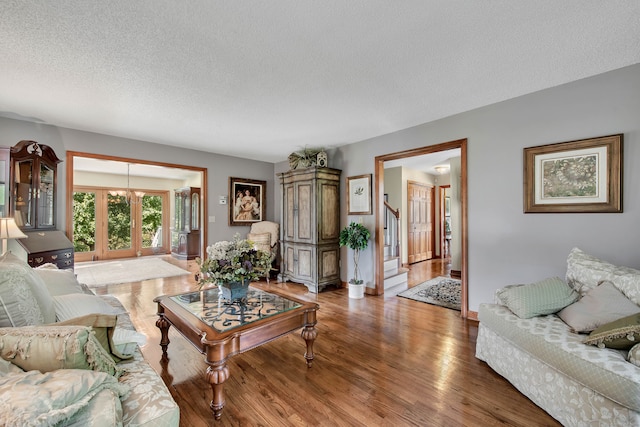 living room featuring a textured ceiling and hardwood / wood-style floors