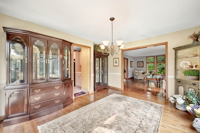 interior space featuring light hardwood / wood-style flooring and a chandelier