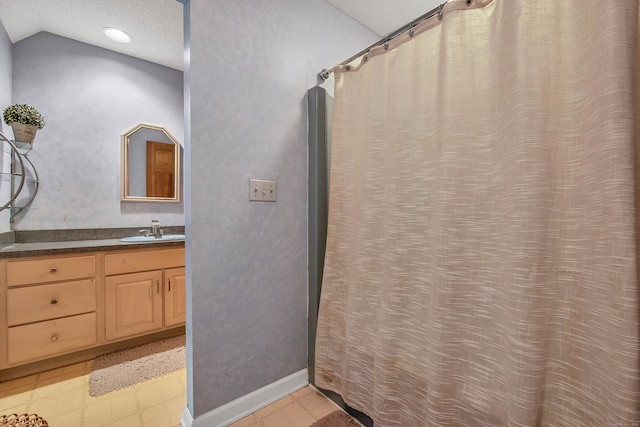 bathroom with vanity and lofted ceiling