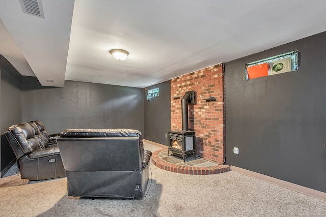 carpeted living room featuring a wood stove