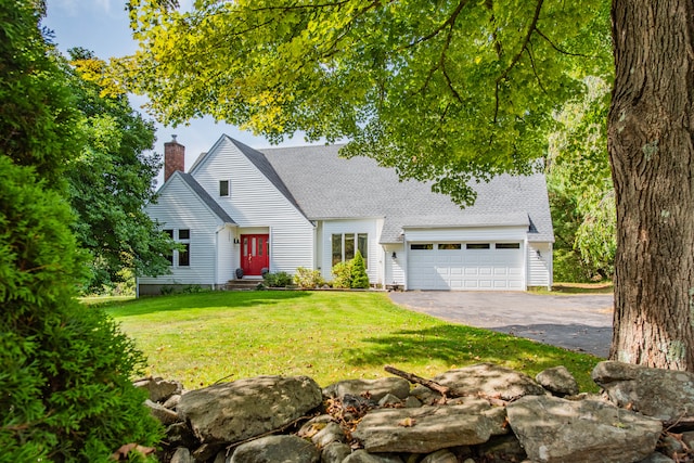 view of front of property featuring a front yard and a garage